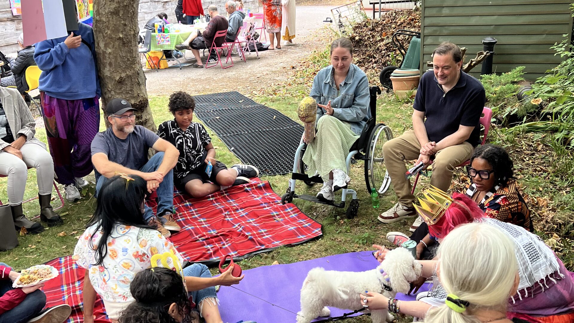 A group of people sat on beanbags and yoga mats talking
